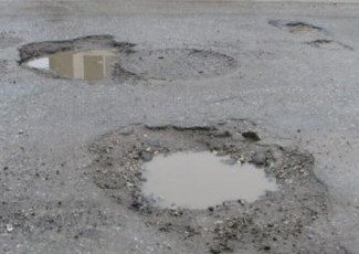 Surface treated road with two potholes